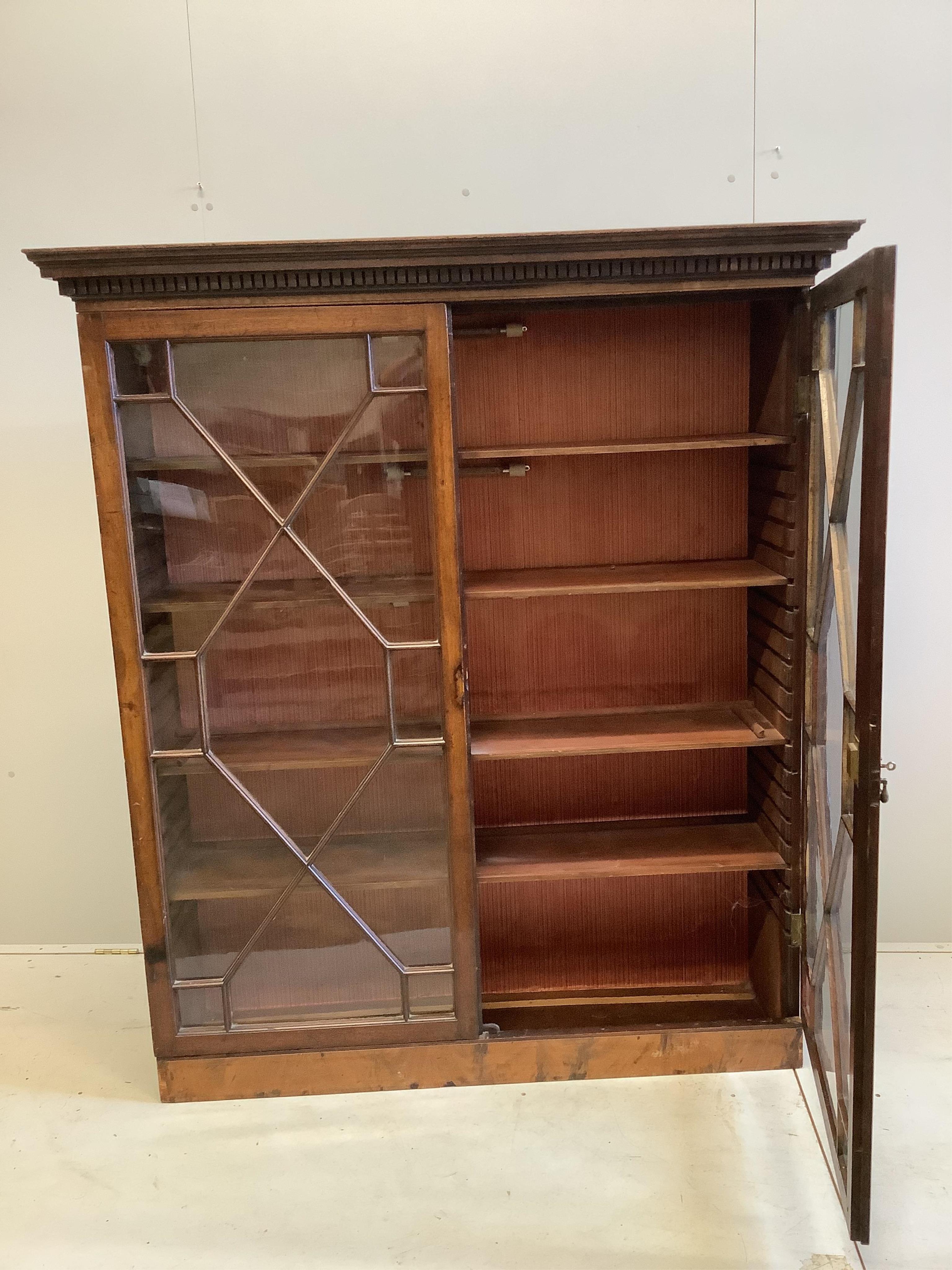 A George III style mahogany two door astragal glazed bookcase, adapted, width 137, depth 40cm, height 158cm. Condition - fair